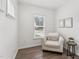 Bright sitting room with a comfortable chair, side table, and views of the street at 3194 Retama Run, New Hill, NC 27562