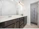 Bathroom with dual sinks, dark wood cabinets and shower at 321 Conrad Ln, Wake Forest, NC 27587