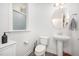 Cozy half bathroom features neutral decor and a pedestal sink at 321 Conrad Ln, Wake Forest, NC 27587