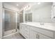 Modern bathroom with double vanity, large mirror, and glass-enclosed tiled shower at 321 Conrad Ln, Wake Forest, NC 27587