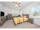 Cozy bedroom features a ceiling fan and two windows at 321 Conrad Ln, Wake Forest, NC 27587