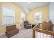 Cheerful Bedroom features a gray rocker, day bed, and whimsical Winnie-the-Pooh wall decorations at 321 Conrad Ln, Wake Forest, NC 27587
