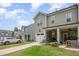Charming townhome with well-manicured front lawn, covered porch, and attached garage at 321 Conrad Ln, Wake Forest, NC 27587