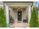 Inviting covered front porch with decorative plants and seating area, perfect for relaxing at 321 Conrad Ln, Wake Forest, NC 27587