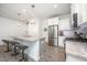 Bright kitchen with stainless steel appliances, granite counters, and island with barstool seating at 321 Conrad Ln, Wake Forest, NC 27587