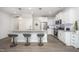 Bright kitchen features white cabinets, stainless steel appliances, granite countertops, and a breakfast bar with seating at 321 Conrad Ln, Wake Forest, NC 27587