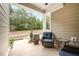 Inviting back patio with outdoor seating and view of landscaped yard and surrounding trees at 321 Conrad Ln, Wake Forest, NC 27587