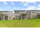 Spacious backyard view featuring lush lawn, mature plantings, and screened in porch at 3224 Star Gazing Ln, Durham, NC 27703