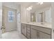 Bright bathroom features double sink vanity, tile floors, and patterned window at 3224 Star Gazing Ln, Durham, NC 27703