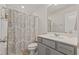 Bathroom features a shower with patterned curtain and neutral vanity at 3224 Star Gazing Ln, Durham, NC 27703