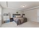 Primary bedroom with plush carpet and a tray ceiling, featuring a comfortable bed and neutral decor at 3224 Star Gazing Ln, Durham, NC 27703