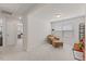 Bonus room with neutral carpet and chair and ottoman. Book shelves and office through doorway at 3224 Star Gazing Ln, Durham, NC 27703