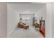 Bonus room with neutral carpet and chair and ottoman. Book shelves and office through doorway at 3224 Star Gazing Ln, Durham, NC 27703