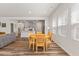 Bright dining area with a wood table, wood floors, and adjacent to the open kitchen and large windows at 3224 Star Gazing Ln, Durham, NC 27703