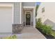 Inviting front entrance with a black door, decorative wreath, stone accents, and manicured shrubs at 3224 Star Gazing Ln, Durham, NC 27703