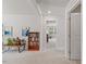 Bright hallway with neutral carpet and doors to the living spaces at 3224 Star Gazing Ln, Durham, NC 27703