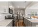 Modern open-concept kitchen with gray cabinetry, stainless steel appliances, and a white subway tile backsplash at 3224 Star Gazing Ln, Durham, NC 27703