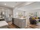 Modern open-concept kitchen with gray cabinetry, stainless steel appliances, and an island at 3224 Star Gazing Ln, Durham, NC 27703