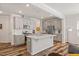 Modern open-concept kitchen with gray cabinetry, stainless steel appliances, and an island at 3224 Star Gazing Ln, Durham, NC 27703