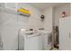 Bright laundry room with a washer and dryer, storage shelf and some cleaning supplies at 3224 Star Gazing Ln, Durham, NC 27703