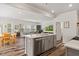 Open-concept living space with kitchen island, dining area and hardwood floors at 3224 Star Gazing Ln, Durham, NC 27703