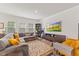 Bright living room with a comfortable gray sectional sofa and large TV at 3224 Star Gazing Ln, Durham, NC 27703