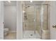 Glass enclosed shower includes tile surround, built-in bench, and hand-held sprayer at 3224 Star Gazing Ln, Durham, NC 27703