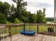 Wooden back deck overlooking a wooded area, with a trampoline at 3292 Longpine Rd, Burlington, NC 27215