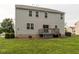 Back exterior view of the home showcasing a gray exterior, deck, and spacious backyard at 3292 Longpine Rd, Burlington, NC 27215