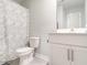 Clean bathroom featuring a toilet, modern vanity, and patterned shower curtain at 3292 Longpine Rd, Burlington, NC 27215