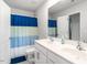 Bright bathroom featuring a double sink vanity, a toilet, and a shower with a colorful curtain at 3292 Longpine Rd, Burlington, NC 27215