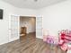 Bright bedroom with French doors, neutral walls, wood floors, and toys at 3292 Longpine Rd, Burlington, NC 27215