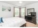 Cozy bedroom with neutral tones, featuring a bed, dresser, and windows for natural light at 3292 Longpine Rd, Burlington, NC 27215