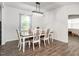 Bright dining area with wood floors, stylish light fixture, and views into an adjacent space at 3292 Longpine Rd, Burlington, NC 27215