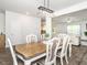 Dining room featuring modern chandelier, wood floors, and views of the living room and kitchen at 3292 Longpine Rd, Burlington, NC 27215