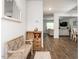 Entryway features a bench, cabinet, wood floors, leading to the living room and dining area at 3292 Longpine Rd, Burlington, NC 27215