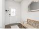 Bright entryway with white door with glass insert, wooden bench, wood floors, and decorative mirror at 3292 Longpine Rd, Burlington, NC 27215
