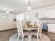 Bright kitchen and dining space featuring white cabinetry and a cozy dining table with seating at 3292 Longpine Rd, Burlington, NC 27215