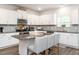 Modern kitchen with granite countertops, white cabinets, and stainless-steel appliances at 3292 Longpine Rd, Burlington, NC 27215