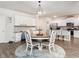 Open kitchen and dining area with a wood table and chairs set on a stylish round rug at 3292 Longpine Rd, Burlington, NC 27215