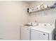 Well-lit laundry room features white appliances and shelving for storage at 3292 Longpine Rd, Burlington, NC 27215