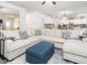 Bright living room featuring a large sectional sofa, stylish throw pillows, and contemporary blue ottoman at 3292 Longpine Rd, Burlington, NC 27215