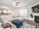 Open concept living room with fireplace, neutral walls, wood floors, and views to kitchen at 3292 Longpine Rd, Burlington, NC 27215