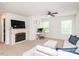 Comfortable living room featuring a fireplace, a large television, and ample natural light at 3292 Longpine Rd, Burlington, NC 27215