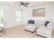 Bright living room featuring a comfortable sofa, ottoman, and an American flag wall decoration at 3292 Longpine Rd, Burlington, NC 27215
