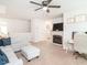 Spacious living room with a cozy fireplace, comfortable seating, and a dedicated office space at 3292 Longpine Rd, Burlington, NC 27215