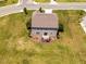 Aerial view of the home's exterior, showing a spacious lawn, patio, and mature landscaping at 3292 Longpine Rd, Burlington, NC 27215