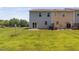 Lush backyard featuring green grass, a patio, and mature trees, creating a serene outdoor space at 3417 Cardinal Lake Dr, Durham, NC 27704