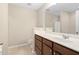 Bathroom featuring wood vanity with white countertop, tiled floors, and a large mirror at 3417 Cardinal Lake Dr, Durham, NC 27704