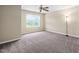 Cozy bedroom featuring carpeted floors, a ceiling fan, and a window with a scenic view at 3417 Cardinal Lake Dr, Durham, NC 27704